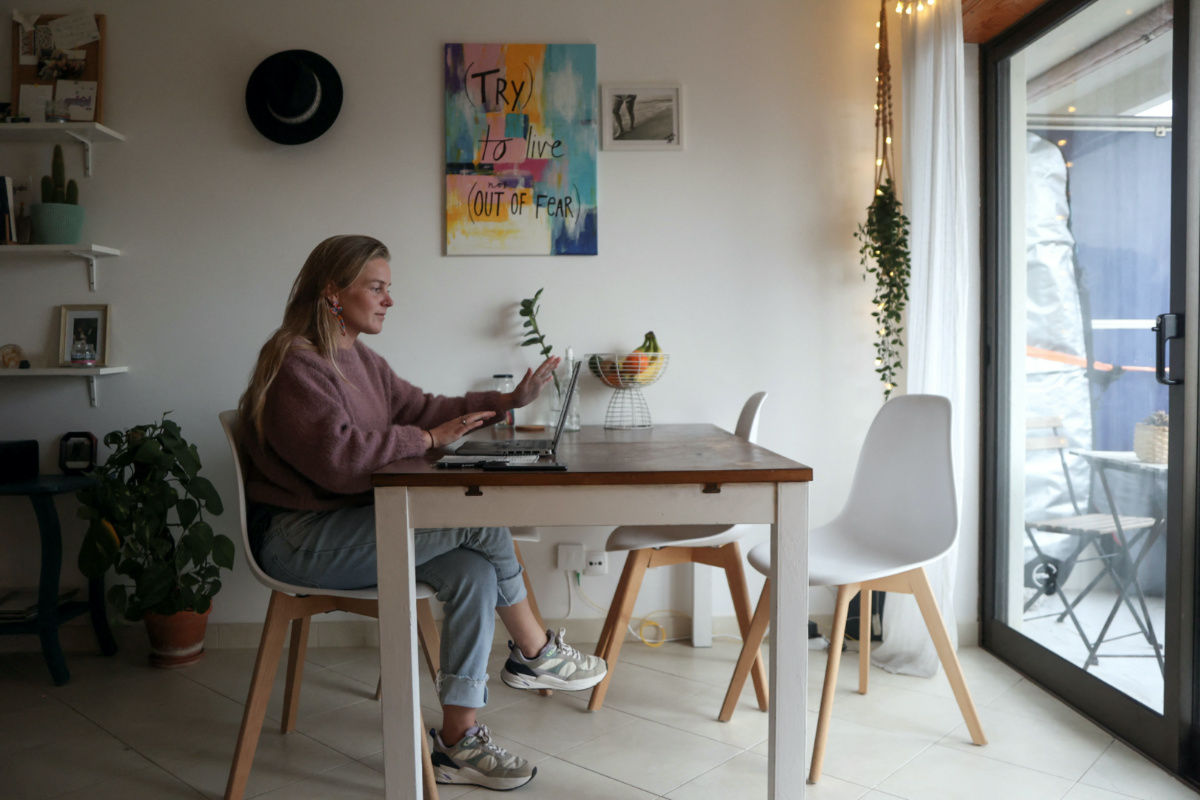 28 years old Esmee from the Netherlands works from home on her rented flat in Costa da Caparica, Portugal, March 6, 2023. REUTERS/Pedro Nunes