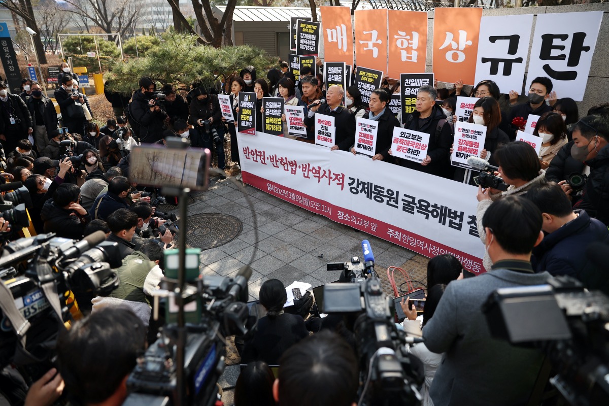 South Korean activists display a message that reads "denouncing anti-national negotiation" as they attend a protest denouncing a plan to resolve a dispute over compensating people forced to work under Japan's 1910-1945 occupation of Korea, in front of the Foreign Ministry in Seoul, South Korea, March 6, 2023.  REUTERS/Kim Hong-Ji