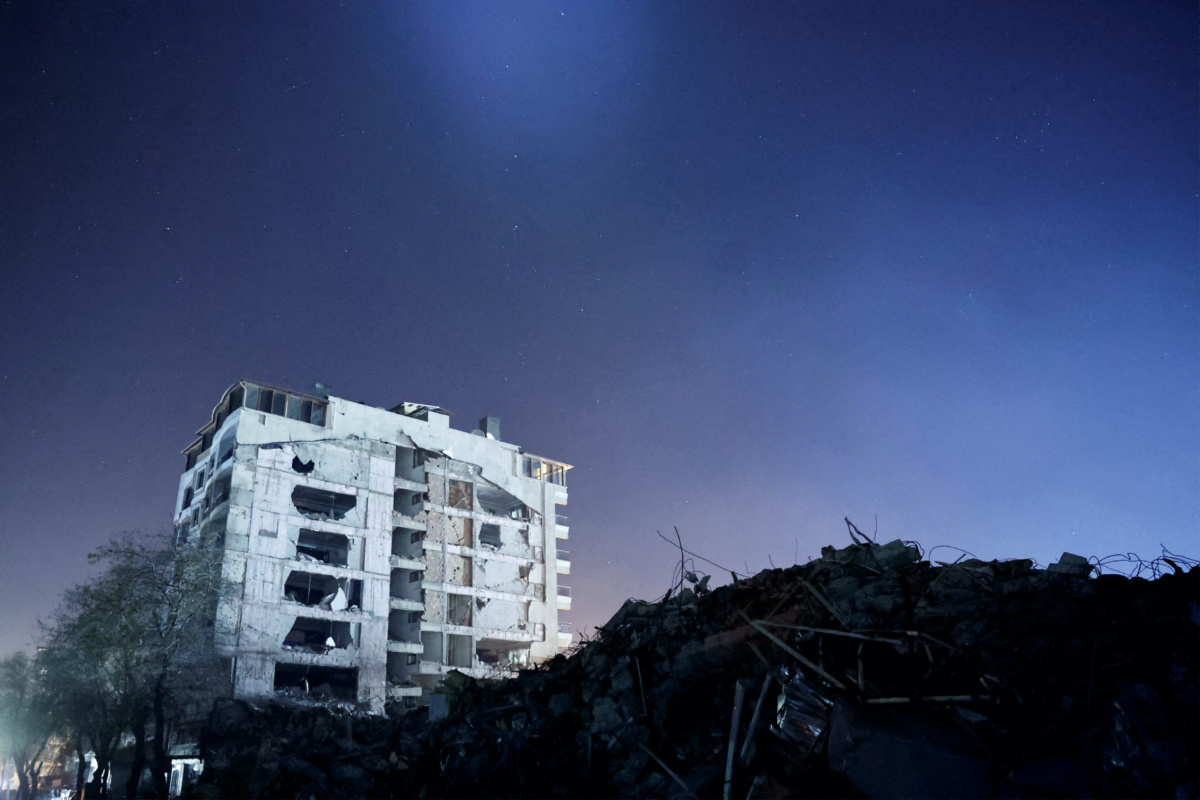A destroyed building is seen at night, in the aftermath of a deadly earthquake, in Antakya, Hatay province, Turkey, February 21 2023. 