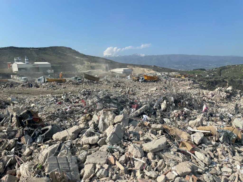 A dump site of earthquake rubble is seen next to a brick and cement block factory on the outskirts of Antakya in Hatay province, Turkey February 25, 2023. REUTERS/Ece Toksabay