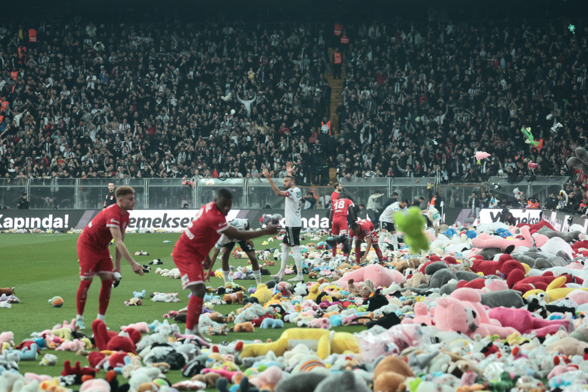 Besiktas' Cenk Tosun reacts as fans throw toys on the pitch for children affected by earthquake during a Turkish Super League match between Besiktas and Antalyaspor at Vodafone Park in Istanbul, Turkey February 26, 2023. REUTERS/Stringer