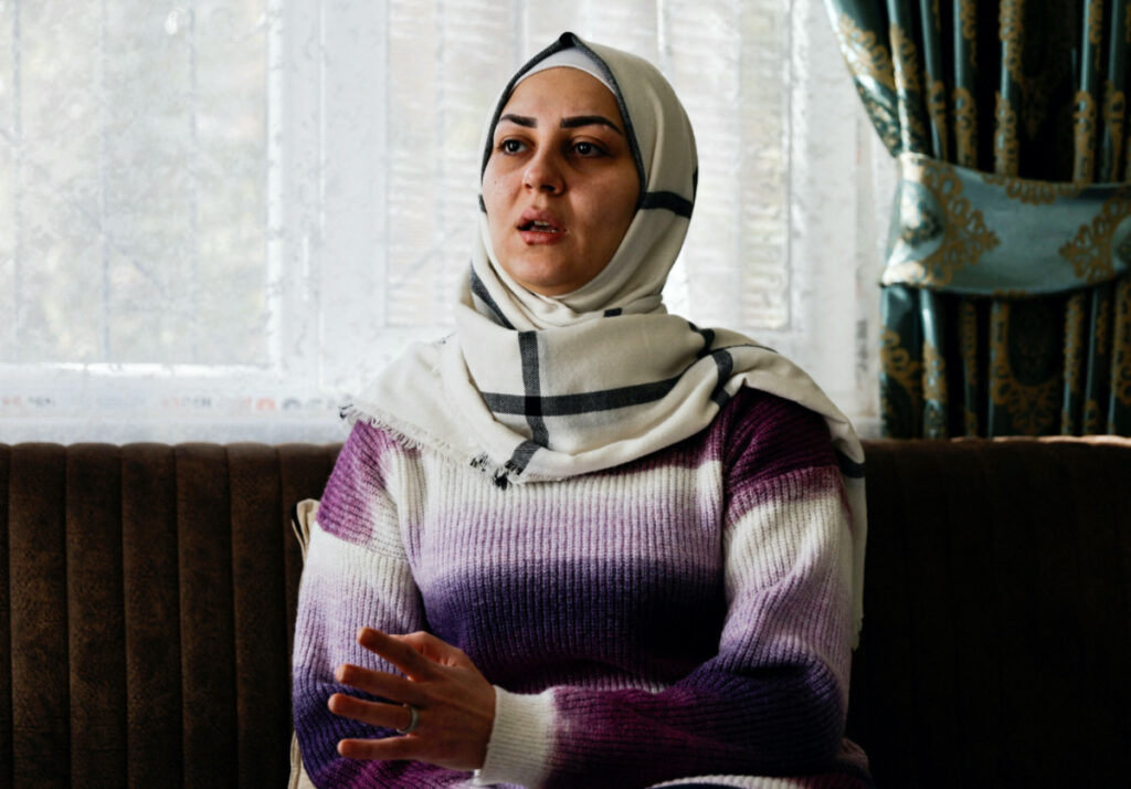 Douaa Idris, who fled Syria with her husband and two children after surviving a chemical weapons attack in 2017, gestures as she speaks during an interview with Reuters in Gaziantep, Turkey, on 14th February, 2023.
