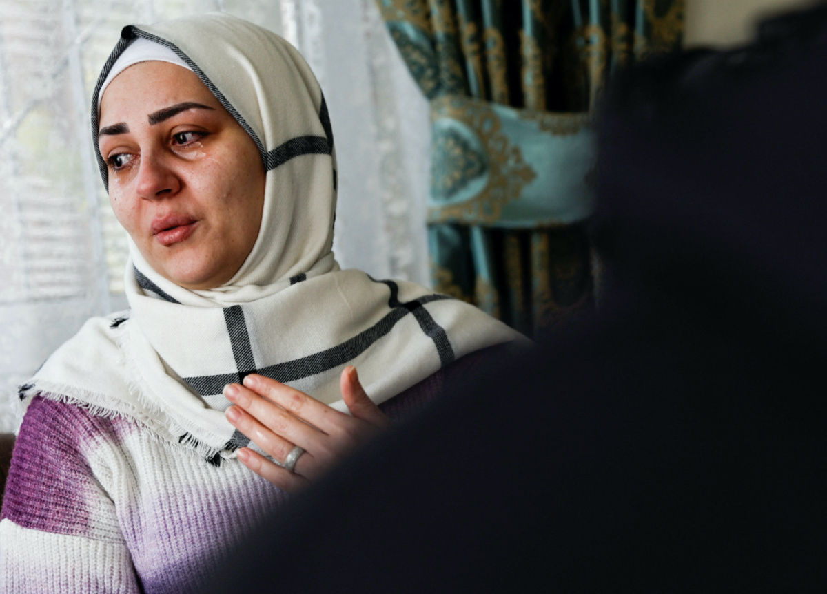 FILE PHOTO-Douaa Idris, who fled Syria with her husband and two children after surviving a chemical weapons attack in 2017, reacts as she speaks during an interview with Reuters in Gaziantep, Turkey, February 14, 2023. REUTERS/Thaier Al-Sudani