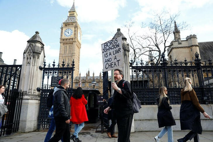 People protest against former British Prime Minister Boris Johnson outside the Houses of Parliament in London, Britain, March 22, 2023. REUTERS/Peter Nicholls