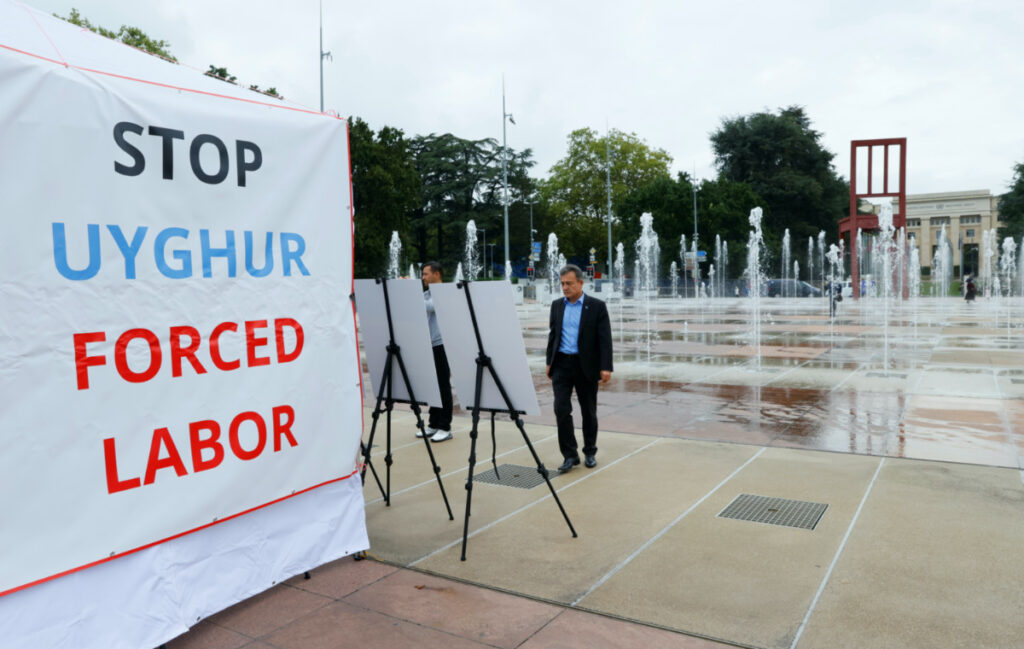 FILE PHOTO: Dolkun Isa, President of the World Uyghur Congress, poses at a United States-backed Uyghur photo exhibit of dozens of people who are missing or alleged to be held in Chinese-run camps in Xinjiang, China in front of the United Nations in Geneva, Switzerland, September 16, 2021. REUTERS/Denis Balibouse