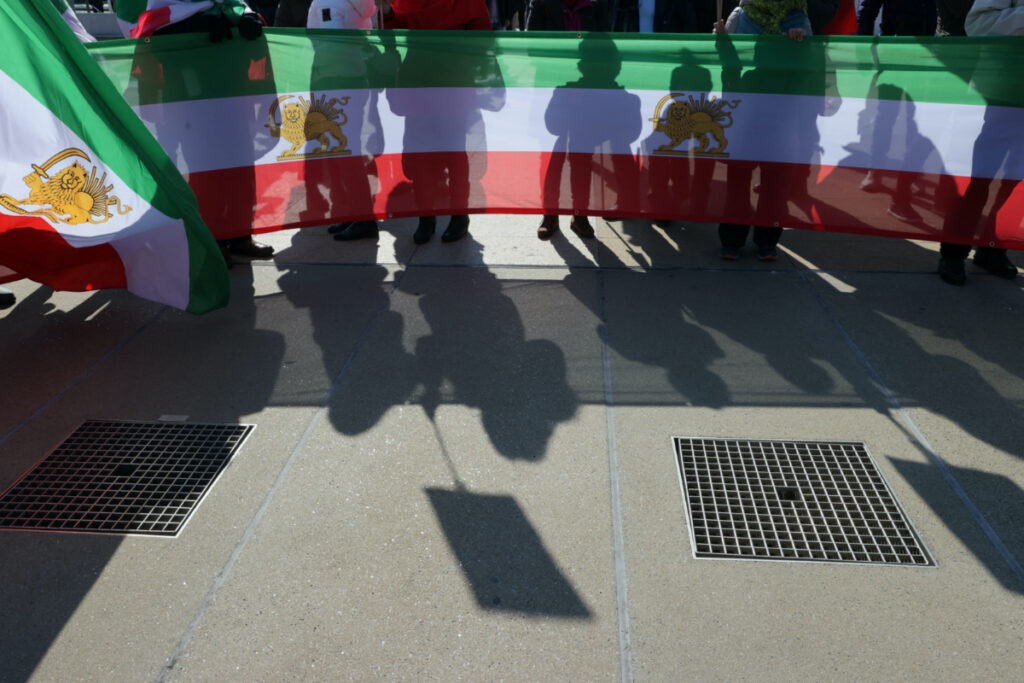 People hold flags during a demonstration against the Republic of Iran in the Place des Nations during the Human Rights Council at the United Nations in Geneva, Switzerland, February 27, 2023. REUTERS/Denis Balibouse/File Photo