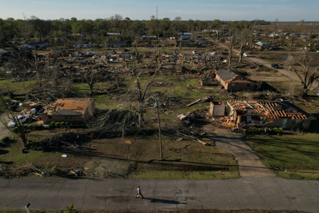 A man walks through the wreckage of a neighborhood after thunderstorms spawning high straight-line winds and tornadoes ripped across the state in Rolling Fork, Mississippi, US, on 27th March, 2023.
