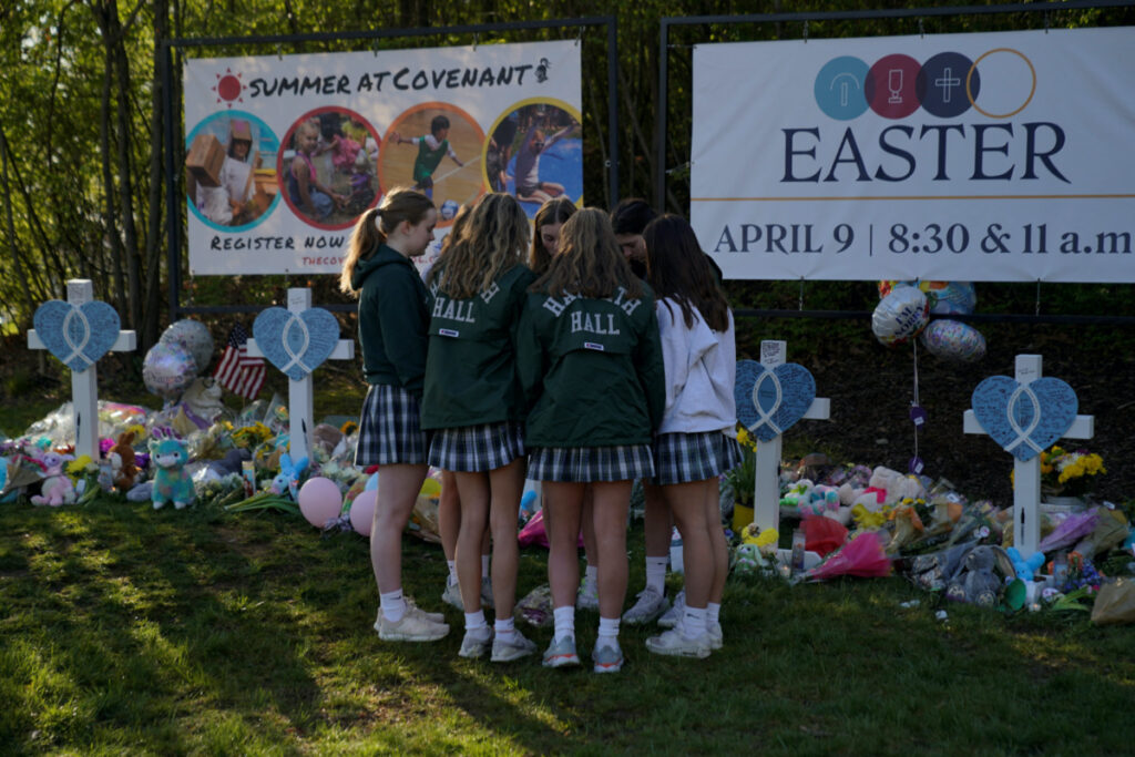 Students from the nearby Harpeth Hall School pray while visiting a memorial at the school entrance after a deadly shooting at the Covenant School in Nashville, Tennessee, U.S. March 29, 2023. REUTERS/Cheney Orr