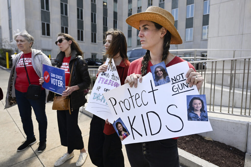 Lauren Giesler holds a sign with photos of her daughters as she joins other activist mothers at a rally at the state Capitol, Tuesday, on 28th March, 2023, in Nashville, Tennessee.