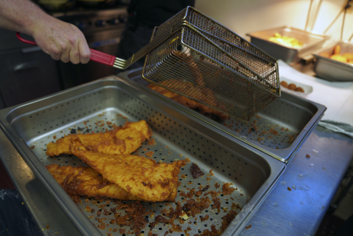 Fried fish is prepared at the Swissvale Fire Department fish fry in Pittsburgh, on Friday, Feb. 24, 2023. 