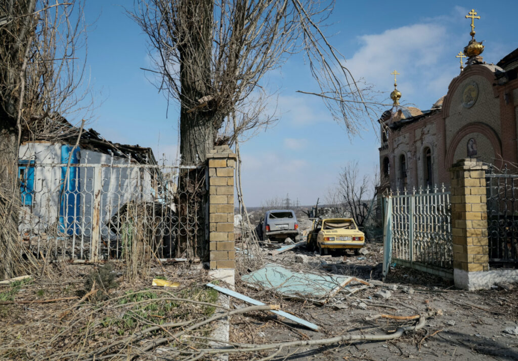 FILE PHOTO: A view shows a residential building, cars and a church damaged by a Russian military strike, amid Russia's attack on Ukraine, in the frontline city of Avdiivka, in Donetsk region, Ukraine March 20, 2023. REUTERS/Alex Babenko/File Photo