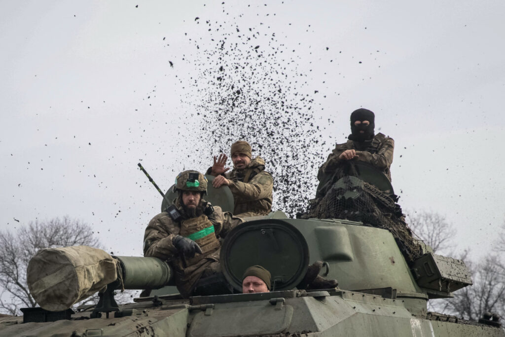 FILE PHOTO: Ukrainian service members ride a self-propelled howitzer, as Russia's attack on Ukraine continues, near the frontline city of Bakhmut, Ukraine February 27, 2023. REUTERS/Yevhen Titov