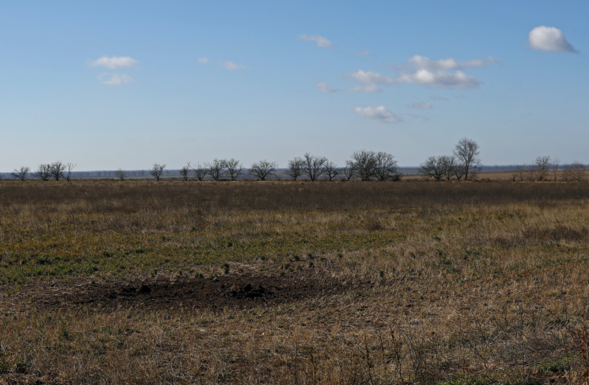 A view of the depression from shelling in field of grain farmer Andrii Povod that has been damaged by shelling and trenches, amid Russia's invasion of Ukraine, in Bilozerka, Kherson region, Ukraine, February 20, 2023.