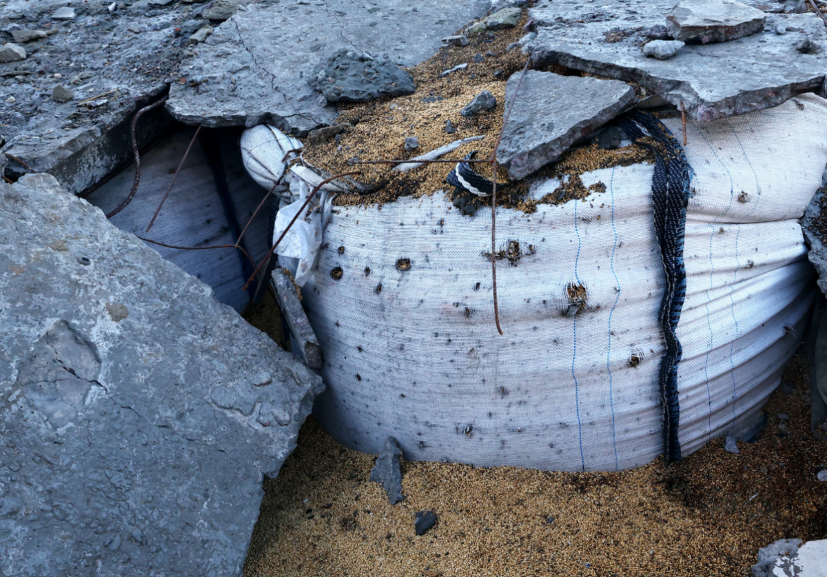 Debris lies on a sack of grain at the farm of Andrii Povod, amid Russia's invasion of Ukraine, in Bilozerka, Kherson region, Ukraine, February 20, 2023.