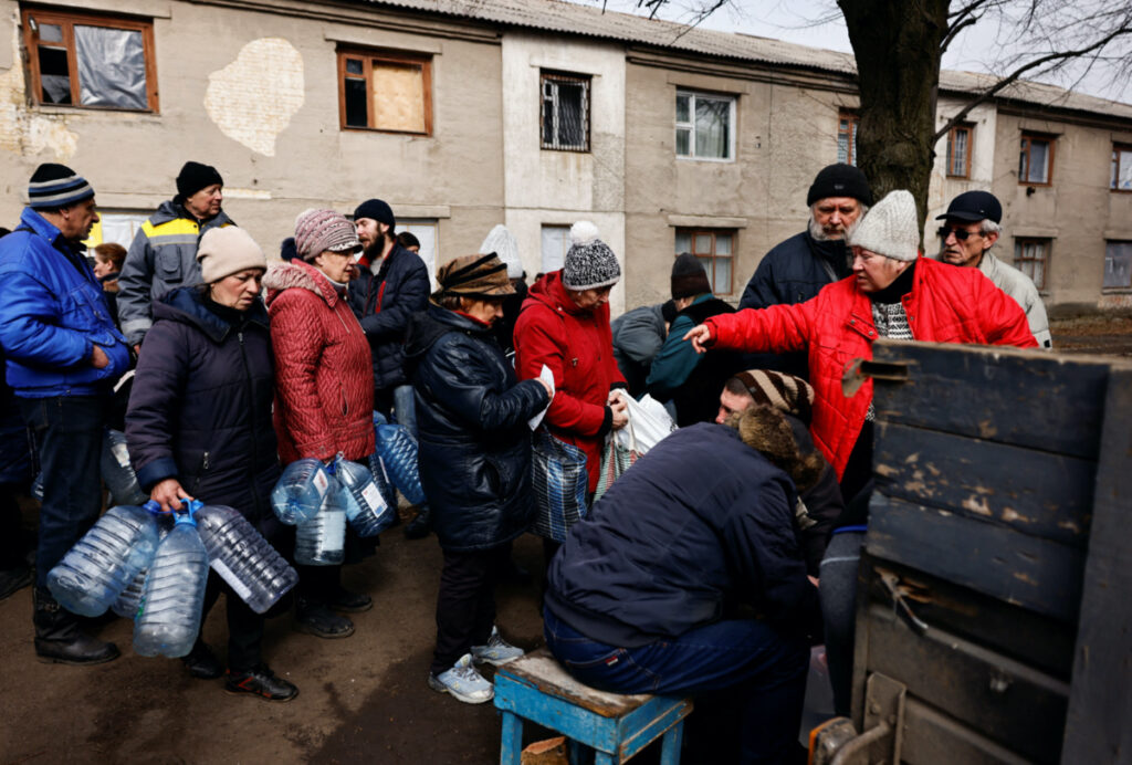 Residents queue to fill up bottles with fresh drinking water brought in to a neighbourhood near the frontline after critical civil infrastructure was hit amid Russia's attack on Ukraine, in Chasiv Yar, Ukraine, on 21st March, 2023.