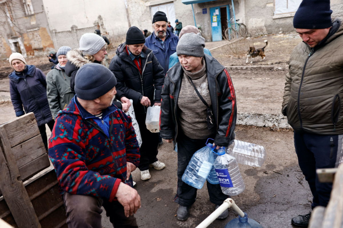 Residents fill up bottles with fresh drinking water brought in to a neighborhood near the frontline after critical civil infrastructure was hit amid Russia's attack on Ukraine, in  in Chasiv Yar, Ukraine March 16, 2023.