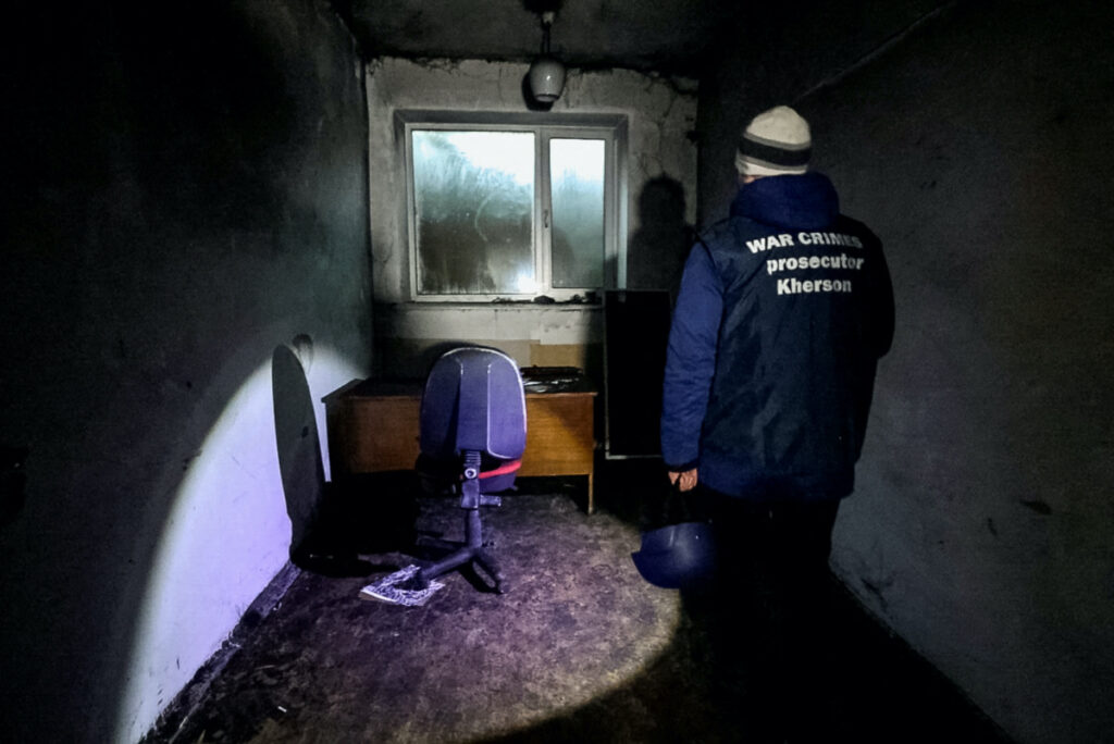 A war crime prosecutor inspects a basement of an office building, where prosecutor's office says 30 people were held for two months during the Russian occupation, amid Russia's attack on Ukraine, in Kherson, Ukraine December 20, 2022.