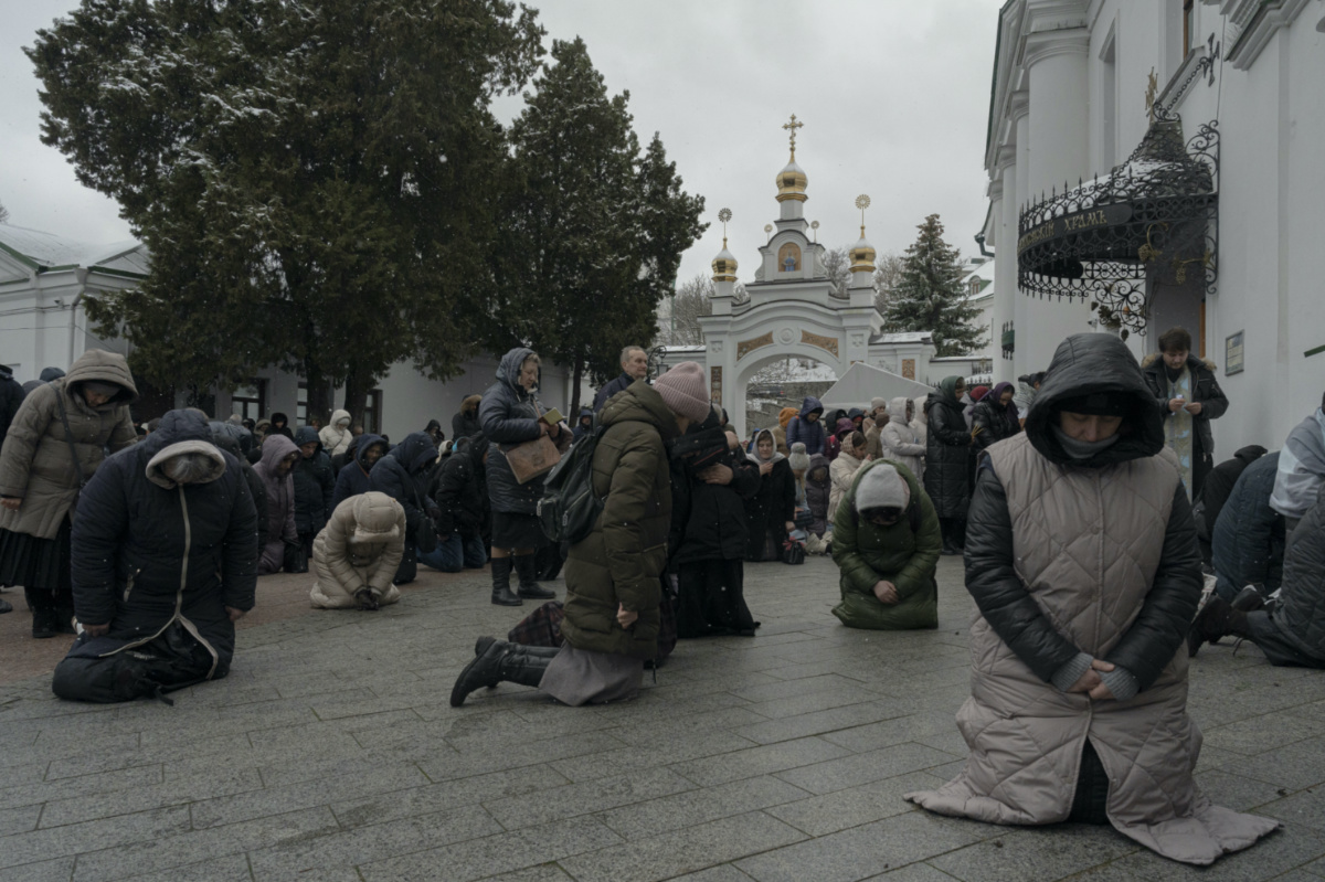 People pray in the Kyiv Pechersk Lavra monastery complex in Kyiv, Ukraine, Wednesday, March 29, 2023. The Russian invasion of Ukraine is reverberating in a struggle for control of a monastery complex. The government says it's evicting the Ukrainian Orthodox Church from the complex as of March 29, accusing it of pro-Russia actions and ideology. (AP Photo/Andrew Kravchenko)