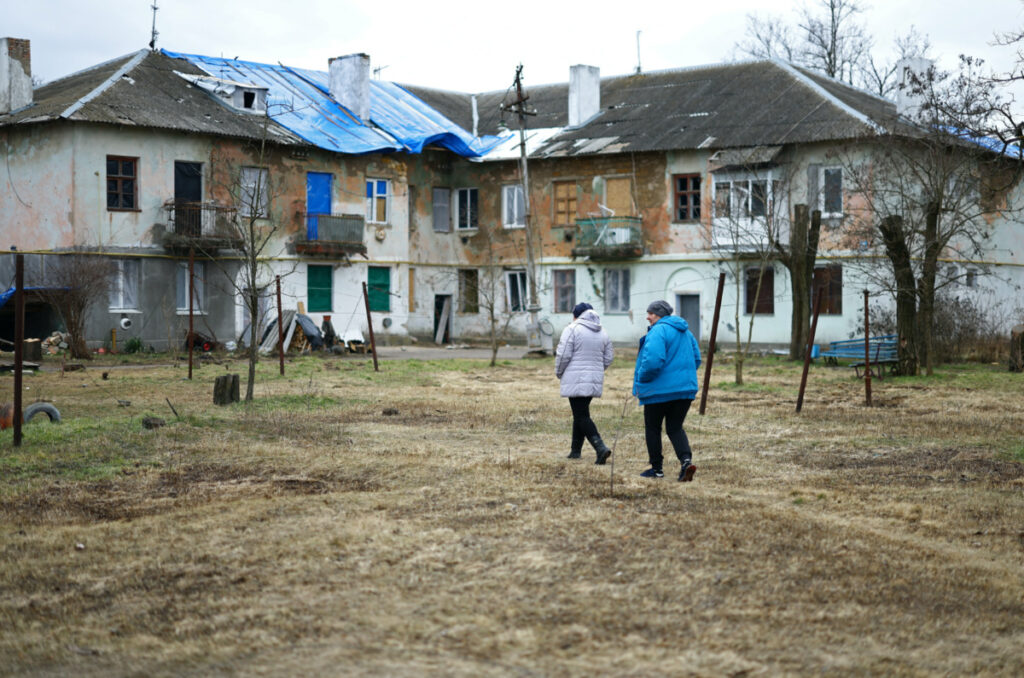 Svitlana Gynzhul and Iryna Sichkar, residents of a former Soviet nuklear bunker, cross their hometown that was located between front lines and devastated by shelling in the beginning of the war, amid Russia's invasion of Ukraine, in Luch, Mykolaiv region, Ukraine, February 24, 2023.