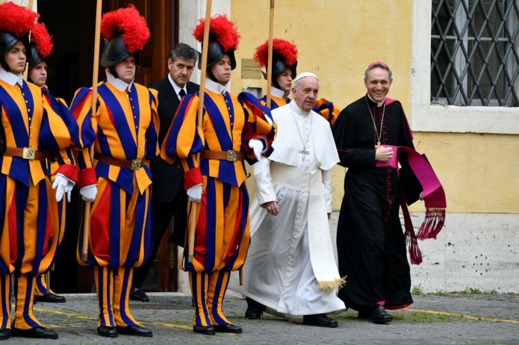 Pope Francis, flanked by Archbishop Georg Gaenswein, walks past Swiss Guards on is way to a private audience with Britain's Prince Charles and his wife Camilla, Duchess of Cornwall, at the Vatican, April 4, 2017.