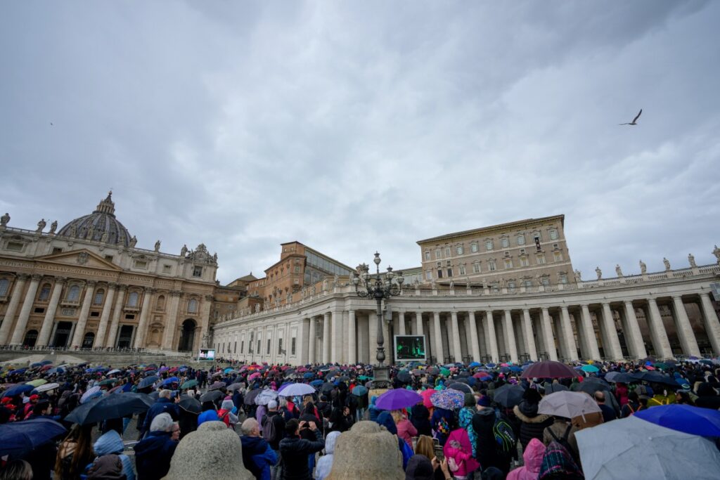FILE - People crowd St. Peter's Square at the Vatican as Pope Francis delivers his blessing as he recites the Angelus noon prayer from the window of his studio, Sunday, Feb. 26, 2023. Pope Francis gave clear indications about the need to get out of a disastrous London real estate deal by saying the Vatican must “start over and lose as little money as possible” in negotiating an exit strategy that eventually involved paying off a London-based Italian broker 15 million euros, the Holy See’s No. 3 official told a court Thursday, March 16, 2023. (AP Photo/Andrew Medichini, FIle)