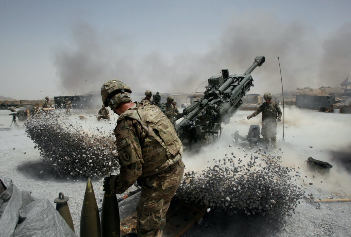 US Army soldiers from the 2nd Platoon, B battery 2-8 field artillery, fire a howitzer artillery piece at Seprwan Ghar forward fire base in Panjwai district, Kandahar province southern Afghanistan, on 12th June, 2011.