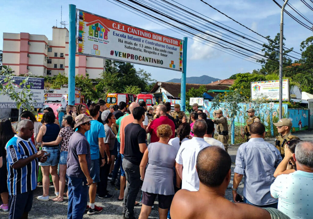People stand outside a pre-school after a 25-year-old man attacked children, killing several and injuring others, according to local police and hospital, in Blumenau, in the southern Brazilian state of Santa Catarina, Brazil, on 5th April, 2023.