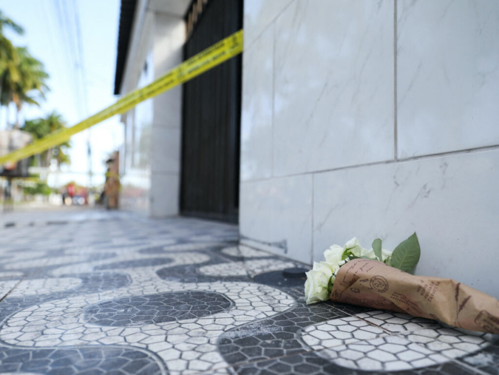 Flowers are seen near civil defence tape outside the Lar Paulo de Tarso shelter for children after a deadly fire in Recife, Pernambuco state, Brazil on 14th April, 2023.