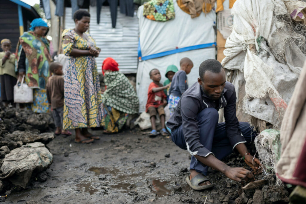 Thomas Tumusifu Buregeya, 22, repairs his mother's tent at the Congo Basin camp for the internally displaced people, in Nyiragongo territory, Goma, North Kivu province, Democratic Republic of Congo, on 6th April, 2023.
