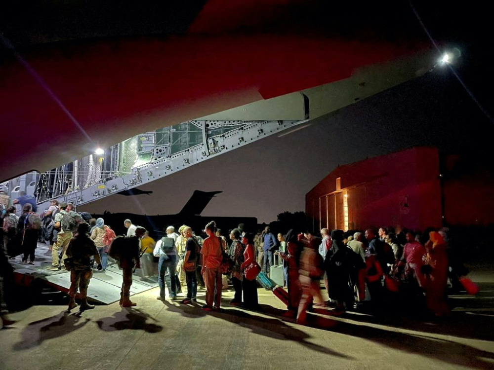 Spanish diplomatic personnel and citizens queue outside a military plane after they were evacuated from Sudan, in Djibouti, Djibouti, on 24th April, 2023.