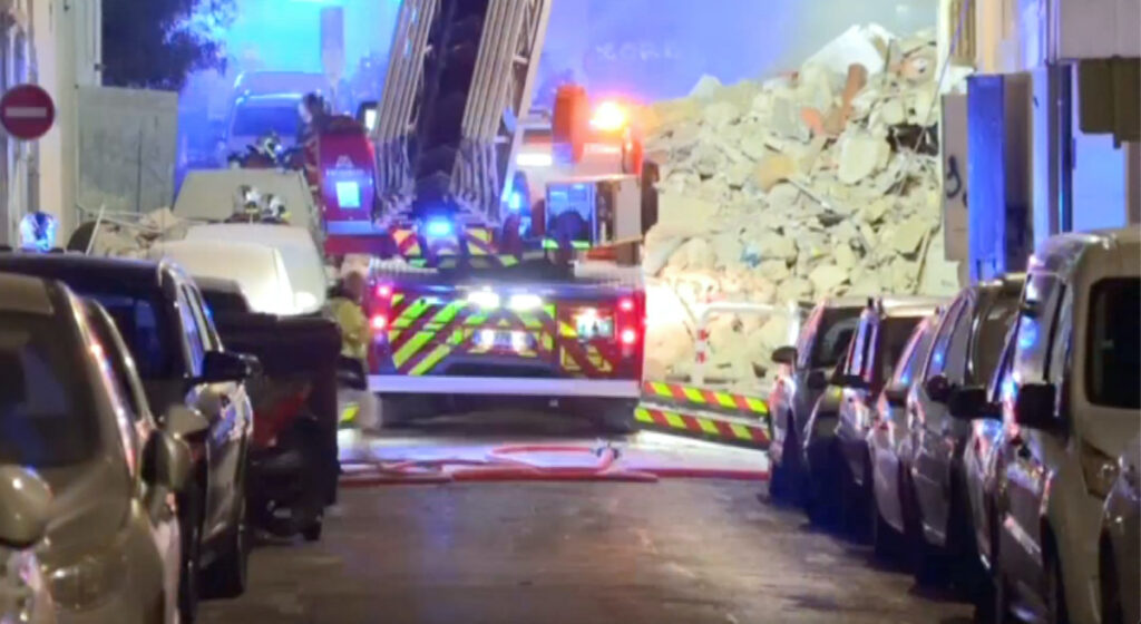 A fire truck stands next to a collapsed building in Marseille, France, on 9th April, 2023, in this screengrab obtained from a social media video.
