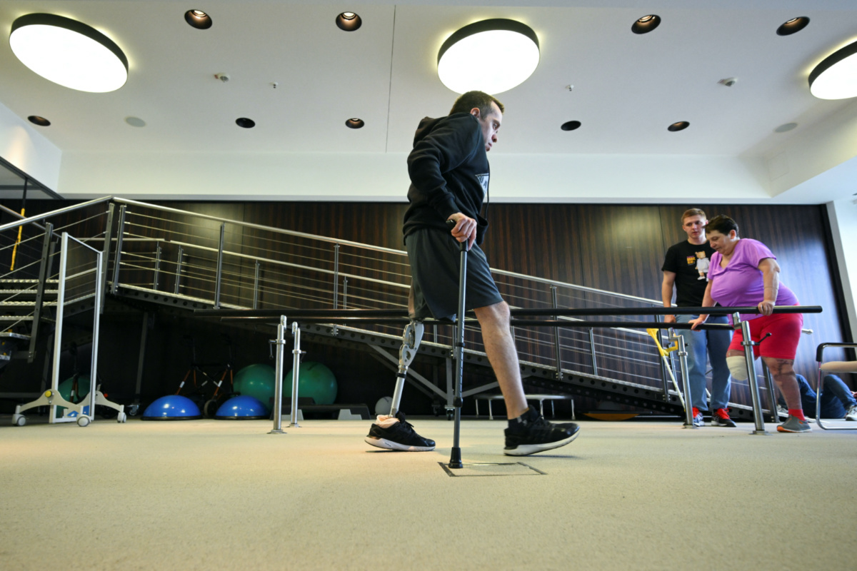 Ukrainian patient Valentin from Popasna walks by Anna from Kherson during her therapeutic exercise at the artificial limb manufacturers Ottobock in Duderstadt, Germany, on 4th April, 2023. 