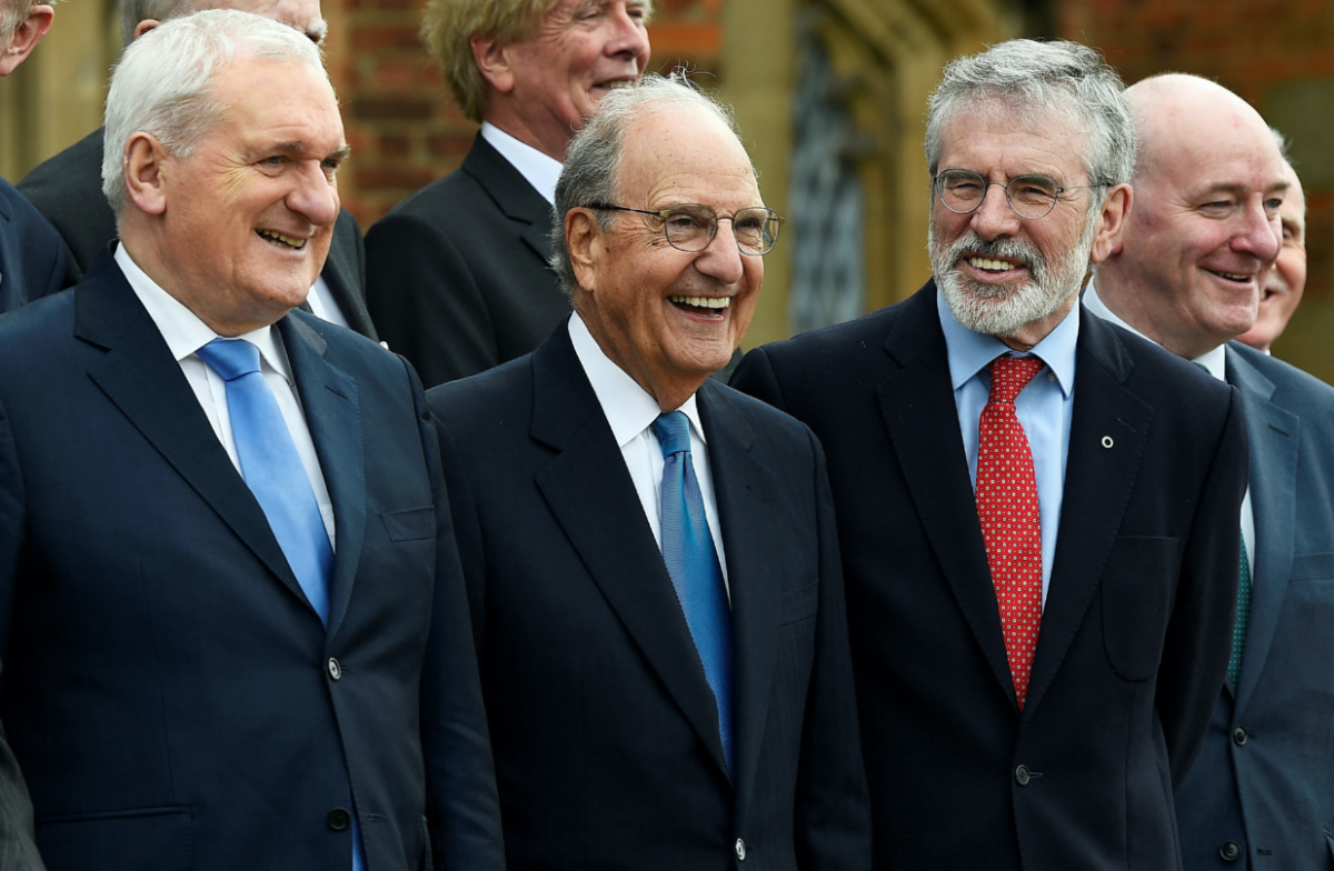 Bertie Ahern, former US Senator George Mitchell and Gerry Adams stand with others for a group photograph at an event to celebrate the 20th anniversary of the Good Friday Agreement, in Belfast, Northern Ireland, on 10th April, 2018. 