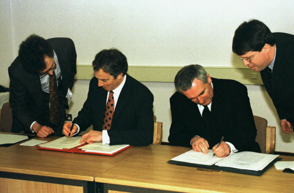 British Prime Minister Tony Blair (L) and Irish Prime Minister Bertie Ahern sign the peace agreement on 10th April, 1998.