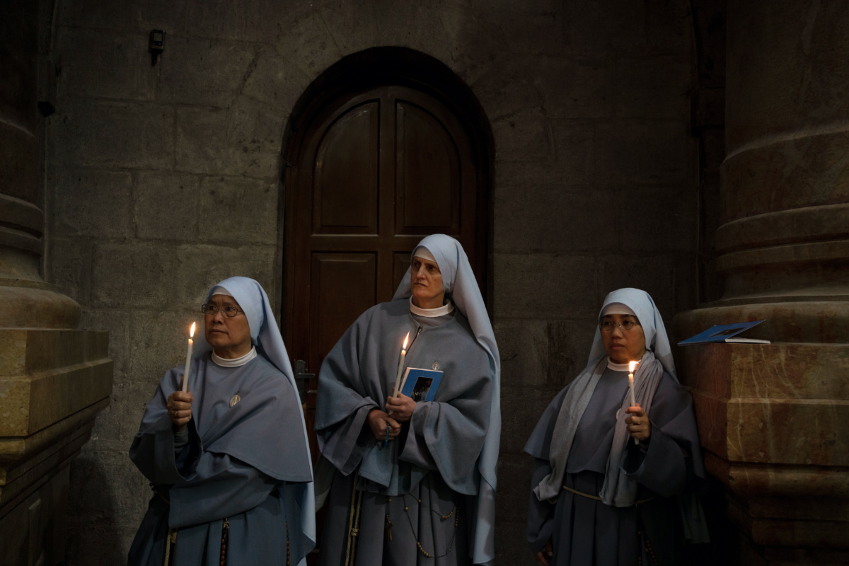 Catholic nuns hold candles during the Holy Thursday procession at the Church of the Holy Sepulchre, the site where according to tradition Jesus was crucified and buried, in the Old City of Jerusalem, on Thursday, 6th April, 2023. 