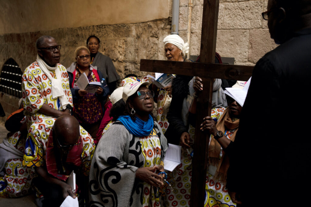 Christians pause along the Via Dolorosa, a route that is believed to be the path Jesus walked to his crucifixion, on Good Friday in the Old City of Jerusalem, on Friday, 7th April, 2023.