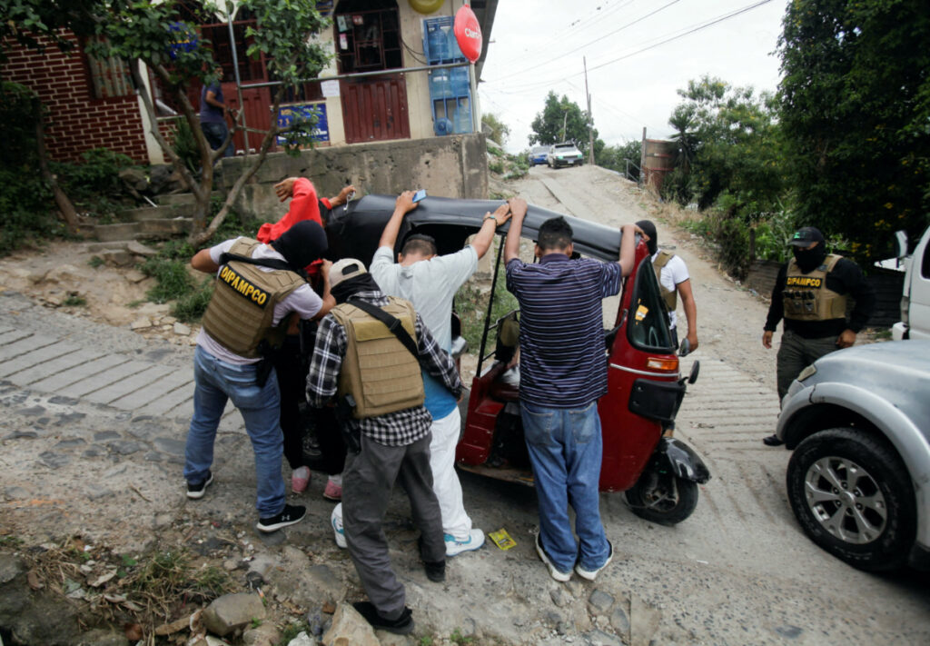 Members of Honduras' DIPAMPCO frisk people while doing rounds in a low-income neighbourhood, after President Xiomara Castro declared a national security emergency implementing a new plan to combat a rising number of cases of extortion by violent criminal groups operating across the country, in Tegucigalpa, Honduras, on 26th November, 2022.