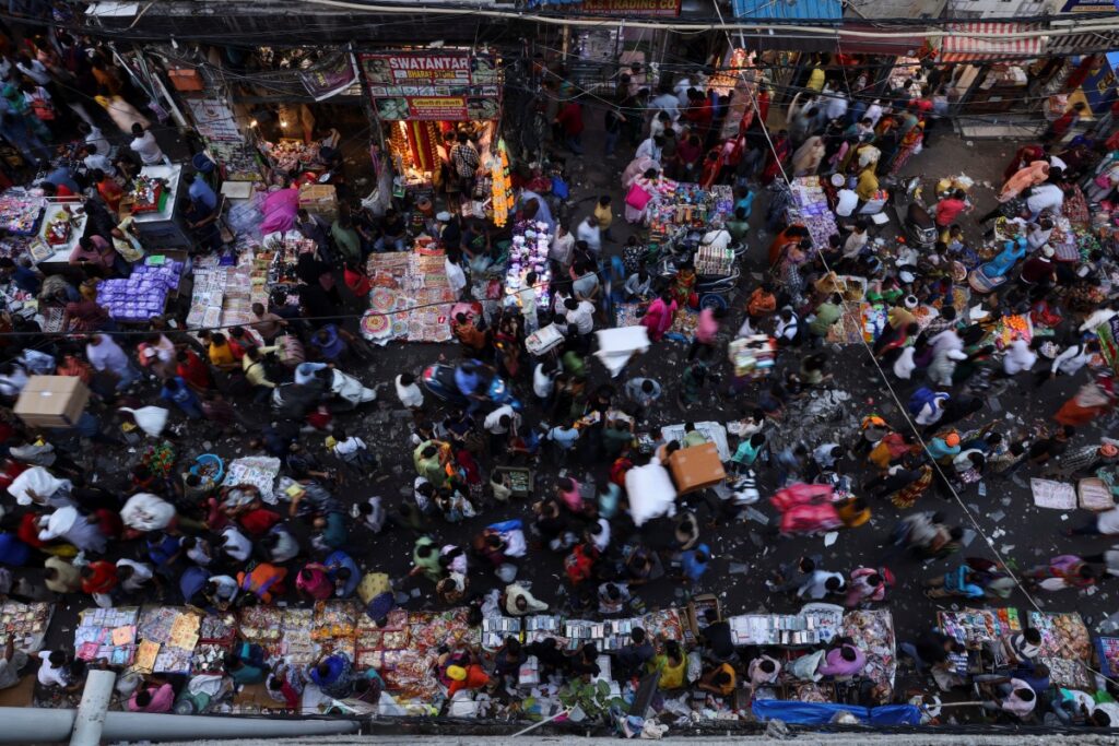 People shop at a crowded market in the old quarters of Delhi, India, on 11th October, 2022