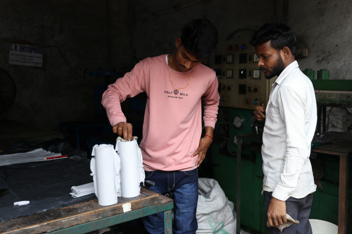 A 21-year-old aspiring college student and migrant worker Sujeet Kumar works at his brother-in-law Sunil Kumar's factory which manufactures rubber sealants for pressure cookers, on the outskirts of Mumbai, India, on 13th March, 2023. 