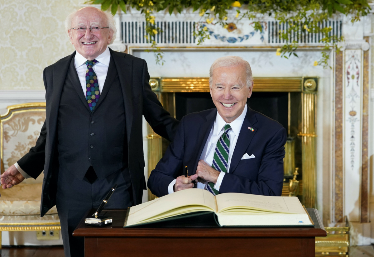 US President Joe Biden signs the guest book, as he meets with Irish President Michael Higgins, in Dublin, Ireland, on 13th April, 2023. 