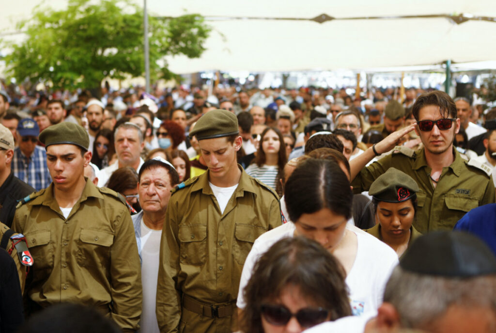 Israeli soldiers and civilians attend a memorial ceremony as a siren sounds on Israel's Memorial Day, in Beersheba, Israel, April 25, 2023.