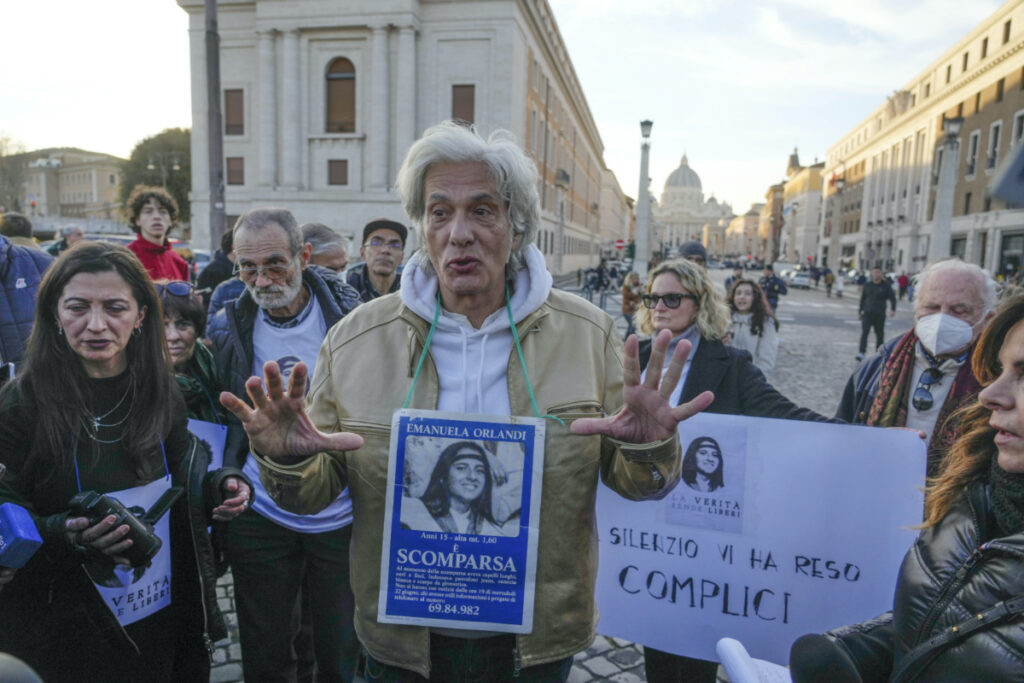 Pietro Orlandi wears a placard with a picture of his sister Emanuela during a sit-in near Saint Peter's Basilica, in Rome, on Saturday, 14th January, 2023