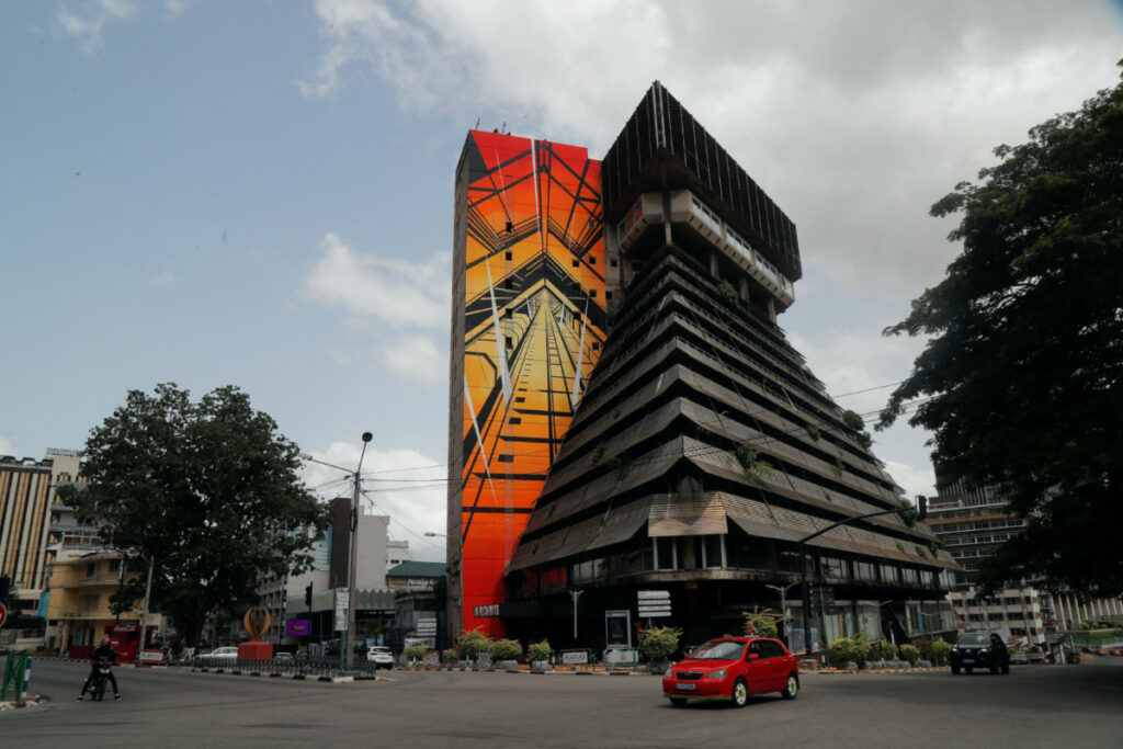 A general view of a mural by French painter Antonin Katre, on a facade of the 'Pyramid', the emblematic tower of the Ivorian capital built in the 1970s and has fallen into disuse for twenty years, in Abidjan, Ivory Coast, on 18th April, 2023.
