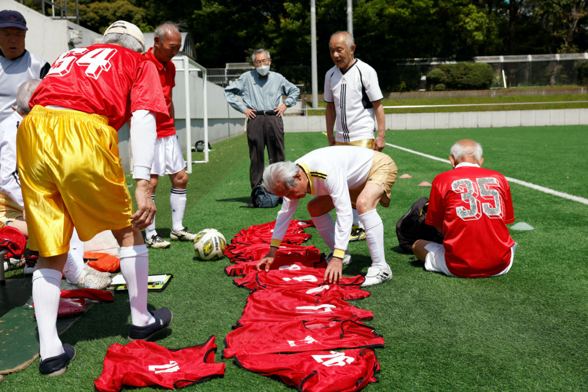 Red Star’s midfielder Mutsuhiko Nomura, 83, arranges soccer vests with the teammates jersey numbers before the SFL 80 League opening match in Tokyo, Japan, on 12th April, 2023.