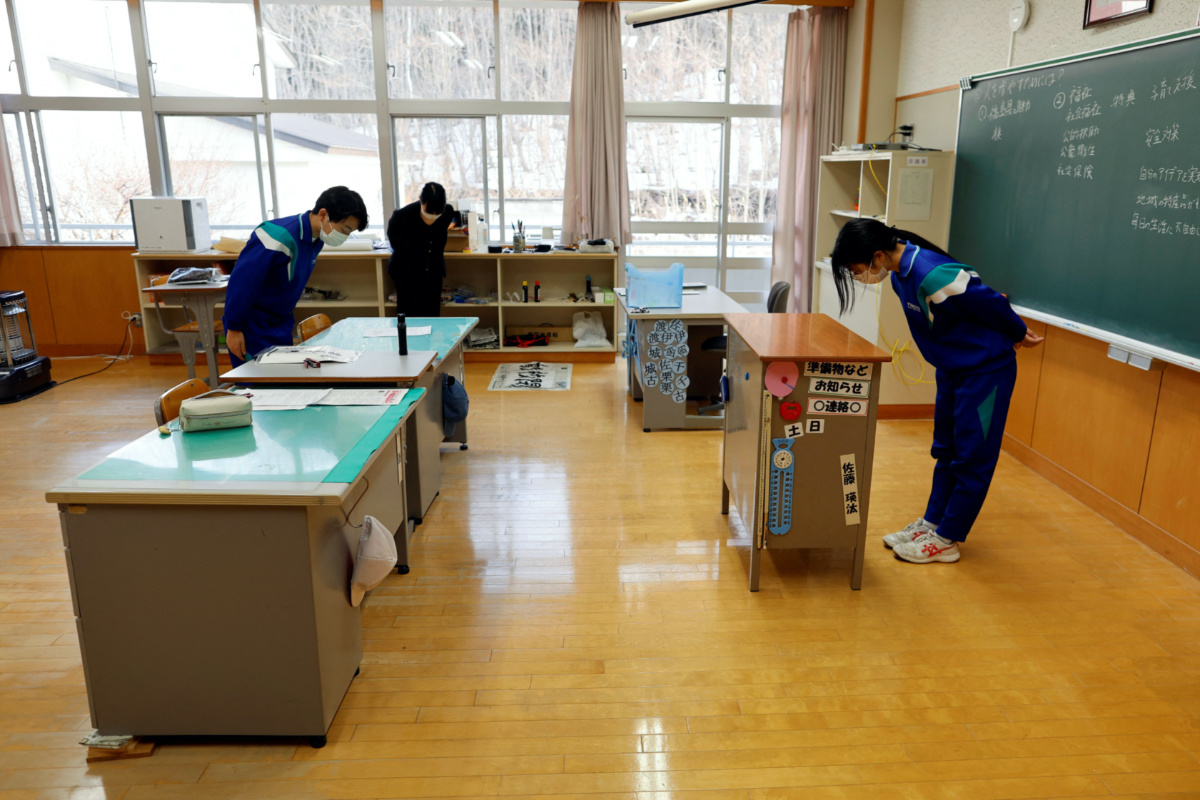 Teacher Yumemi Kanazawa, 30, Eita Sato, 15, and Aoi Hoshi, 15, the only two students at Yumoto Junior High School, attend a class a few days before their graduation and the institution's closing ceremony, in Ten-ei Village, Fukushima Prefecture, Japan, on 9th March, 2023.