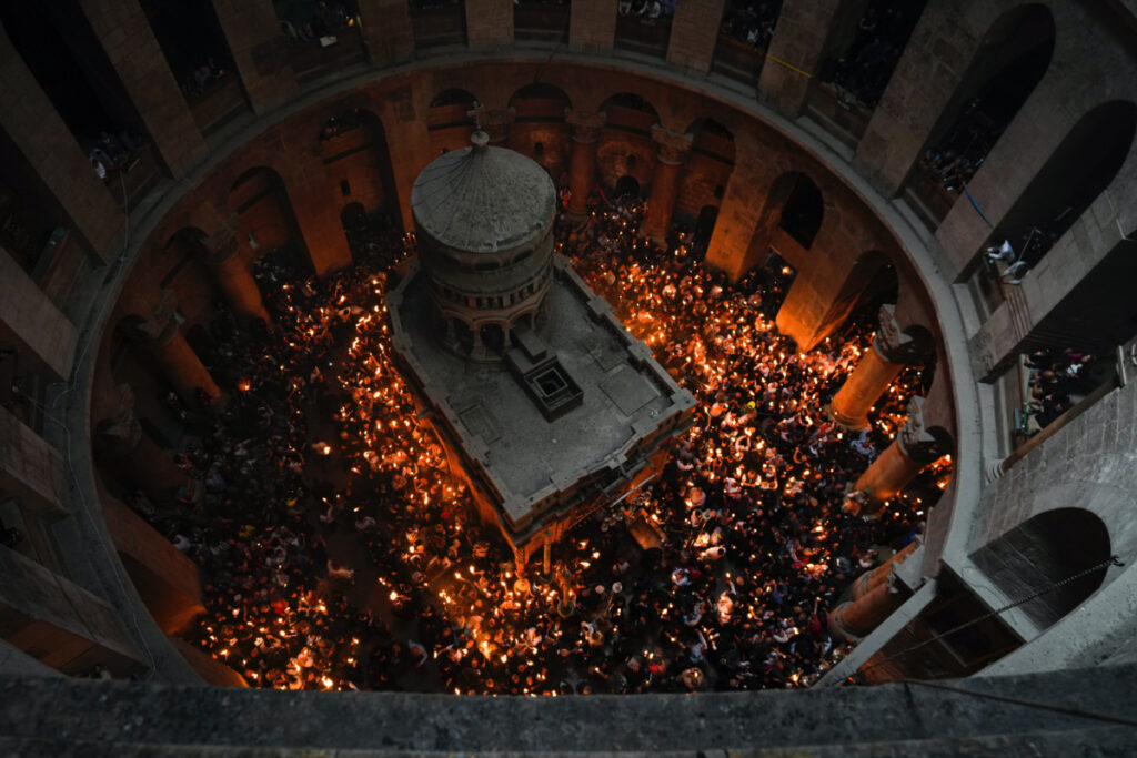 Christians pilgrims hold candles during the Holy Fire ceremony, a day before Easter, at the Church of the Holy Sepulchre, where many Christians believe Jesus was crucified, buried and resurrected, in Jerusalem's Old City, Saturday, 15th April , 2023.