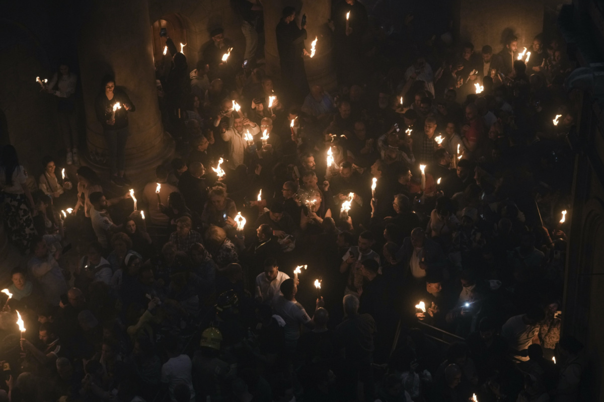 Christians pilgrims hold candles during the Holy Fire ceremony, a day before Easter, at the Church of the Holy Sepulchre, where many Christians believe Jesus was crucified, buried and resurrected, in Jerusalem's Old City, on Saturday, 15th April, 2023. 