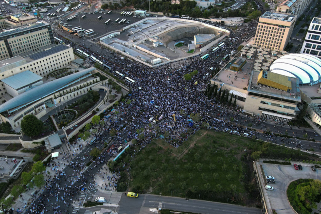 An aerial view shows right-wing demonstrators at a protest calling on the Israeli government to complete its planned judicial overhaul, in front of the Knesset, Israel's Parliament, in Jerusalem, on 27th April, 2023.
