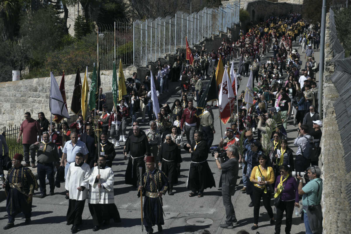 Christians walk in the Palm Sunday procession on the Mount of Olives in east Jerusalem, Sunday, 2nd April, 2023.