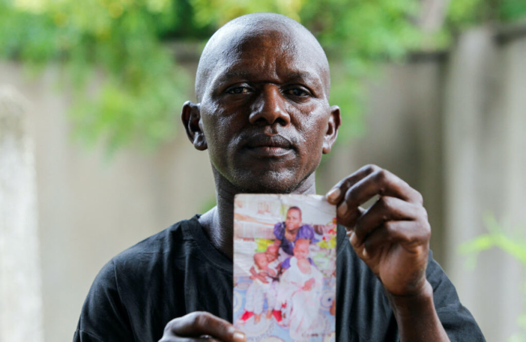 Steven Mwiti holds a photograph of his late wife Joan Bahati, a follower of a Christian cult named Good News International Church, outside the Malindi sub district hospital mortuary in Malindi, Kilifi county, Kenya, on 26th April, 2023.